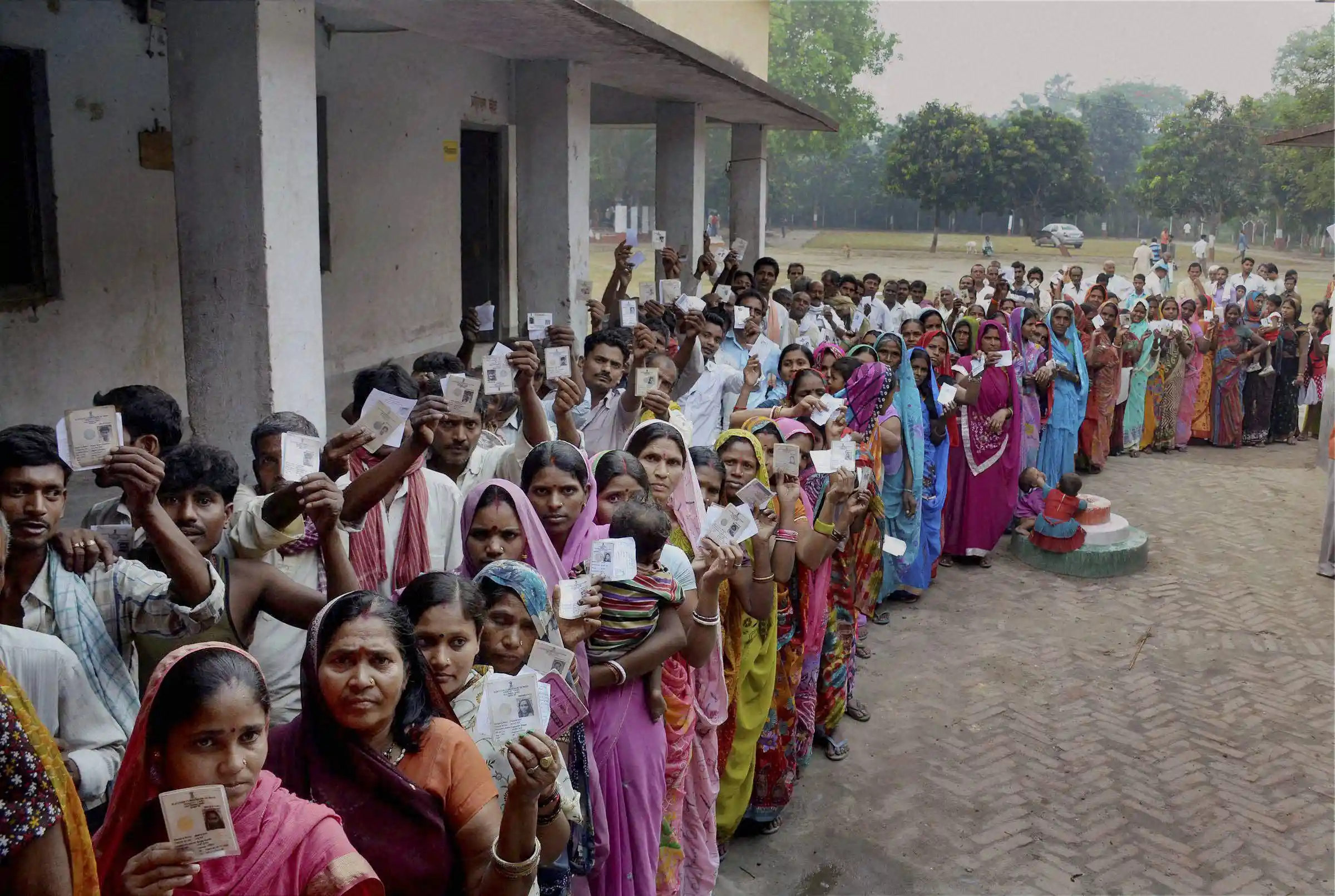 Proof of Democracy; Voters standing in a line to choose their representative; Source: TheWire.in; Public Domain