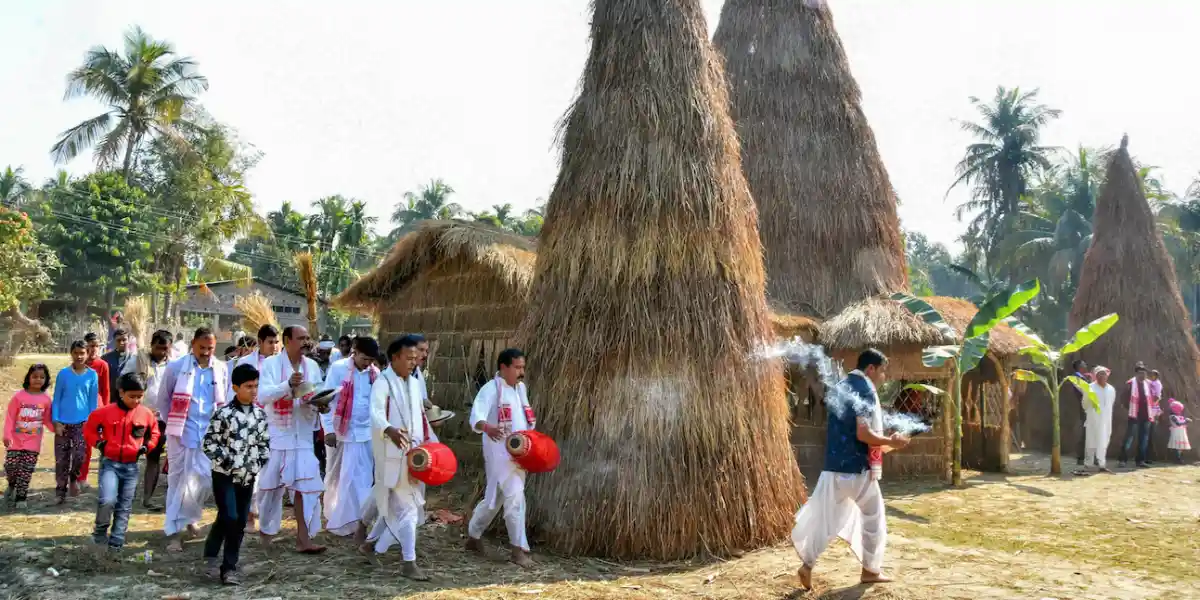 People getting ready to light up the Meji on the morning of Magh Bihu. Source: The Wire