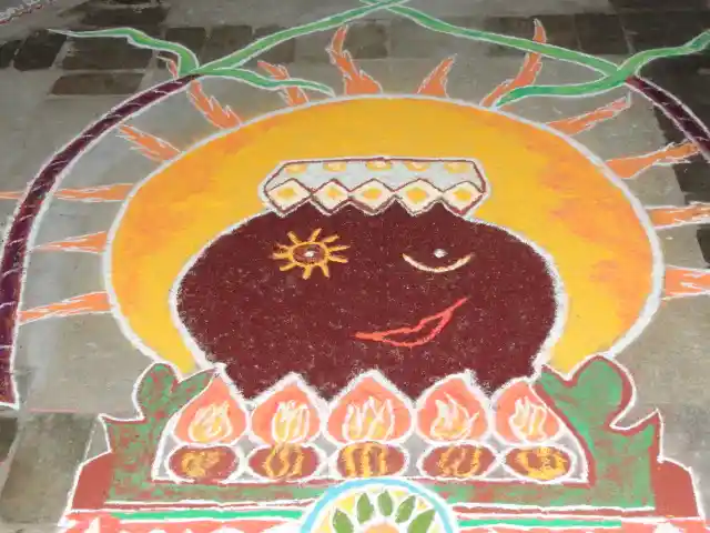 A kolam depicting Pongal being prepared in a traditional pot; Image source: Wikimedia commons