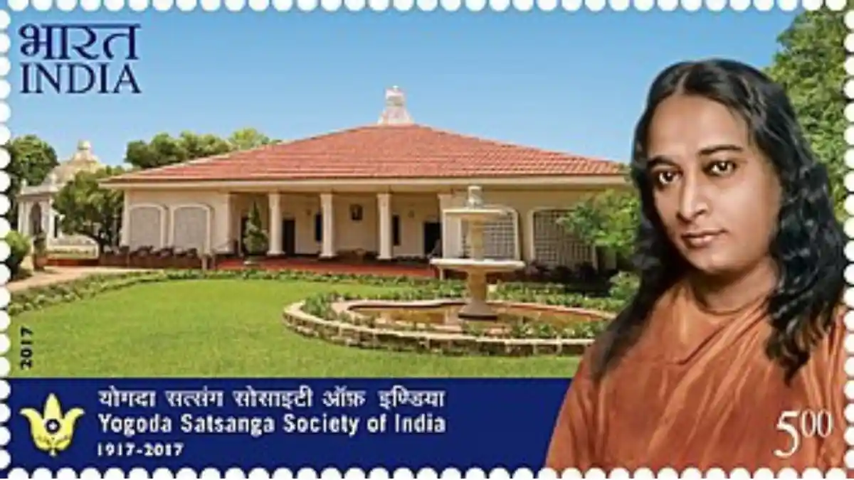 The new Yogananda stamp from 2017 with YSS school at Ranchi in the back. Source: Wikimedia Commons