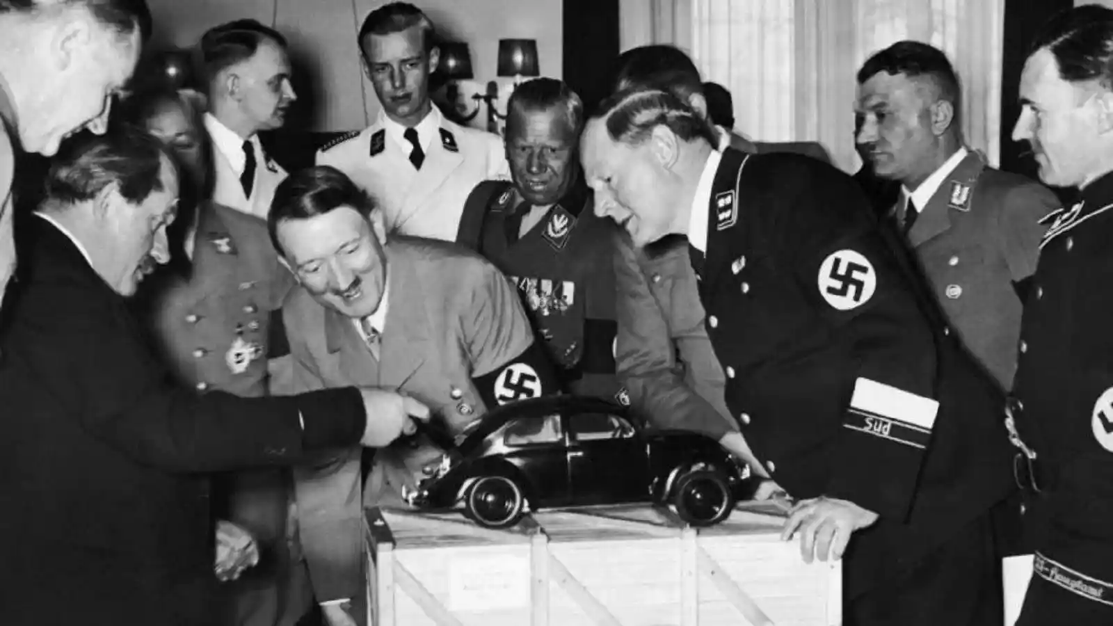 A delighted Adolf Hitler looking at the prototype of the Volkswagen Beetle. Image source: All About History 