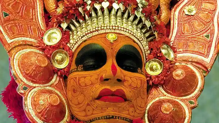 Intricate face painting is vital to Theyyam; Image source: Kerala Tourism